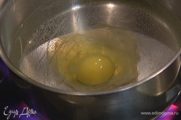 Яйцо разбить в чашку. В небольшое количество кипящей воды влить оставшийся уксус, создать венчиком водоворот и вылить в него яйцо. Убавить огонь до минимума и варить яйцо 1–2 минуты, затем вынуть шумовкой и поместить сверху на салат.