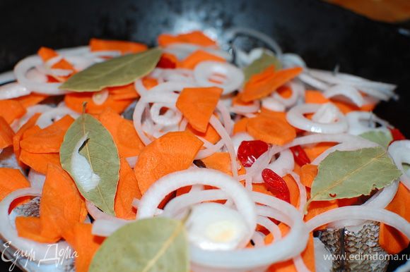 В посуду(кастрюля,сотейник,жаровня) с толстым дном положите рыбу,затем переслоите овощи и лавровый лист.