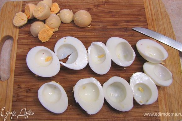 Разрежьте яйца пополам и вытащите желтки. Их можно будет просто раскрошить в бульон. Нарежьте белки кубиками размером с горошину.