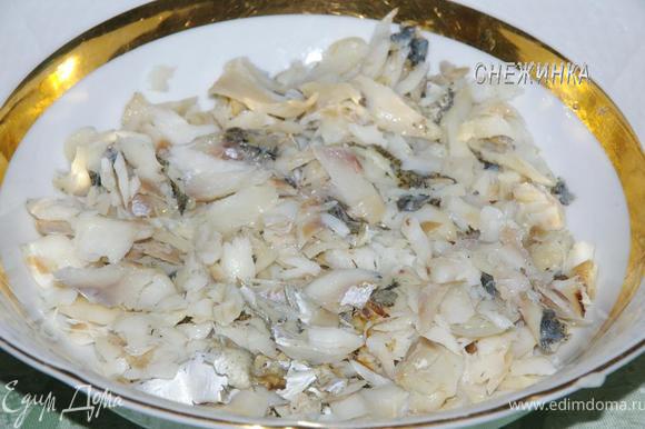 В глубокий салатник укладываем порванную на кусочки и очищенную от костей рыбу.