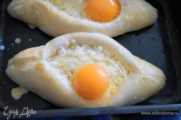 Достать хачапури из духовки, разбить в серединку каждого хачапури яйцо и поставить в духовку еще минут на 5