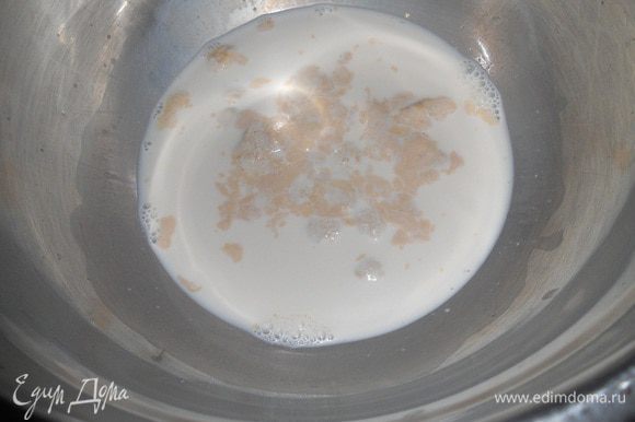 Сливки перемешать с водой, половину отлить в другую миску. В первой миске развести дрожжи, добавив щепотку сахара и оставить постоять 5 минут.