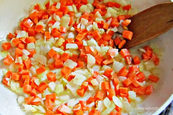Добавить кубики моркови в сковороду и обжарить 3 мин вместе с луком и чесноком.
