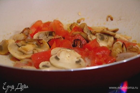 Кубики красного помидора добавить в сковороду с грибами, перемешать и обжаривать на медленном огне 3–4 минуты.