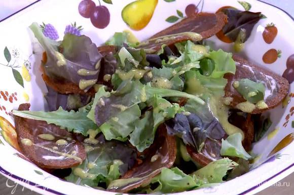 Половину салатных листьев выложить на блюдо, полить частью заправки, сверху разложить бастурму и оставшиеся листья салата, еще немного полить заправкой.