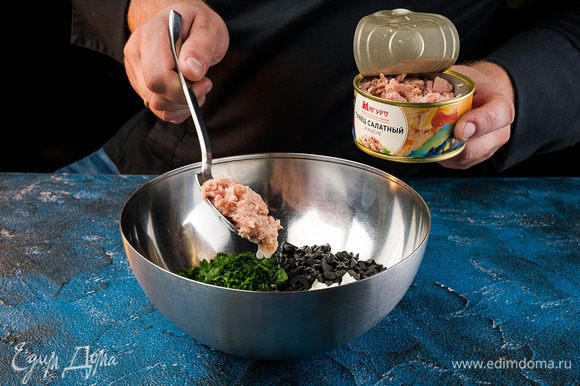 Смешиваем тунец, с маслинами и петрушкой и добавляем 2/3 заправки.