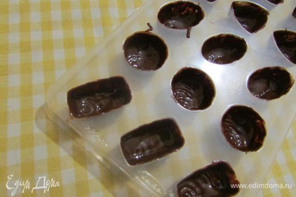 Аккуратно кисточкой нанести слой шоколада по дну и стенкам формы для конфет. Отправить в холодильник на 10 минут. Затем нанести второй слой шоколада. Вновь, поставить в холодильник до полного замерзания.