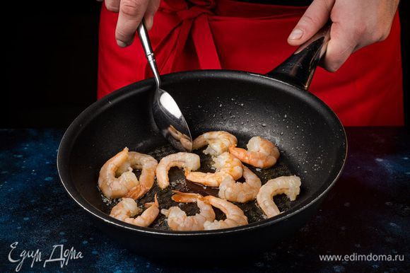 Поставьте сковородку на огонь, хорошо ее нагрейте и смажьте тонким слоем оливкового масла. Выложите очищенные креветки и слегка их обжарьте в течение 2 минут.