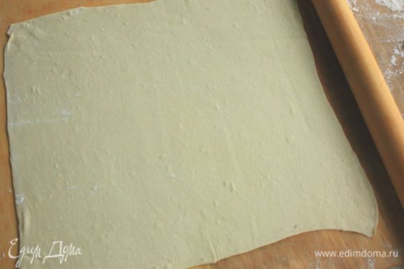 Прямоугольную форму (длиной 25 см, на 1,5 литра) выстлать пекарской бумагой. Слоеное тесто раскатать примерно 32 х 32 см и на скалке перенести в форму.