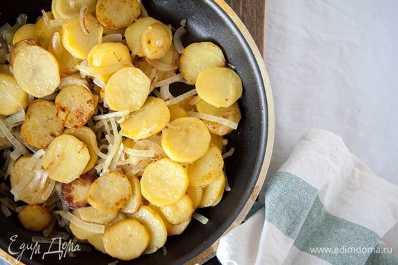 Посолить картофель, добавить лук и продолжать обжаривать до готовности лука, затем снять с плиты.