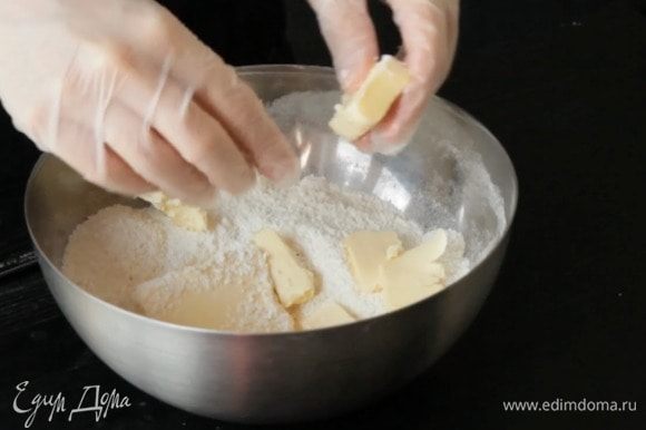 Разогреть духовку до 180°С. Смешать муку, сахар (50 г), кокосовую стружку (85 г) и сливочное масло. Добавить желтки и замесить однородное тесто.