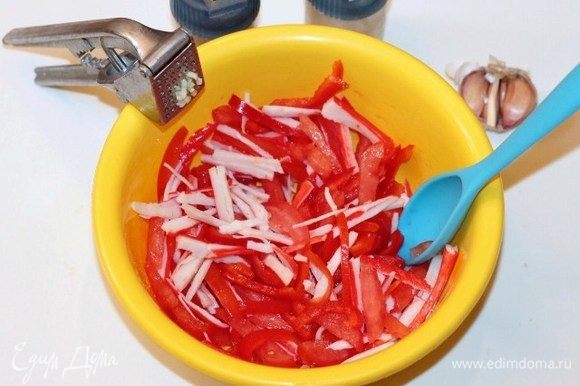 Выкладываем подготовленные продукты в салатник. Добавляем прессованный зубчик чеснока, соль и перец по вкусу.