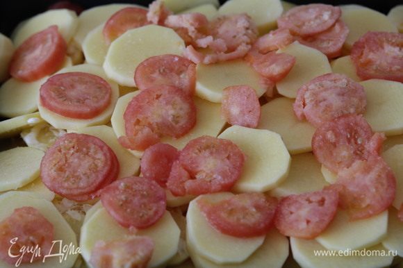 Замороженные помидоры очистить от кожуры и нарезать мелкими пластиками. Выложить на картофель, посолить. Снова добавить сыр и майонез.