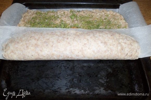 Приподнимая один край пергамента, накрываем овощную начинку рисово-мясной основой.