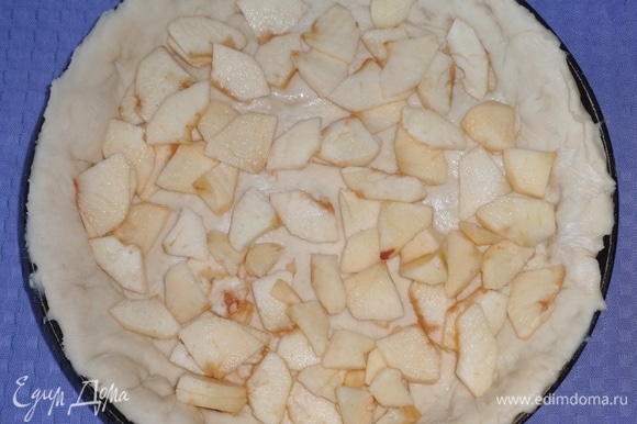Сковороду смазать маслом. Выложить раскатанное тесто на дно и борта сковороды, лишнее тесто срезать. Положить на дно нарезанные яблоки, сбрызнуть лимонным соком.