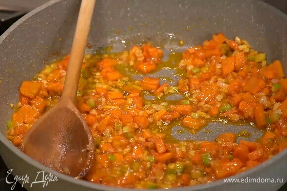 Чеснок почистить, мелко порубить и выложить в сковороду с овощами, добавить томатную пасту, все посолить и перемешать.