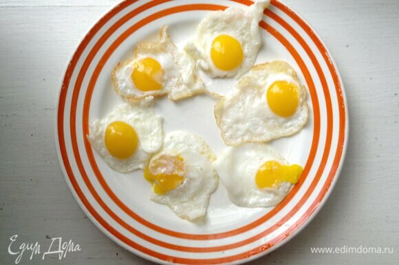 Выложить жареные яйца на тарелку и немного остудить.