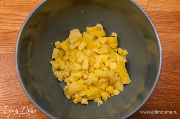 Отваренный картофель нарезать кубиками в большую чашу.