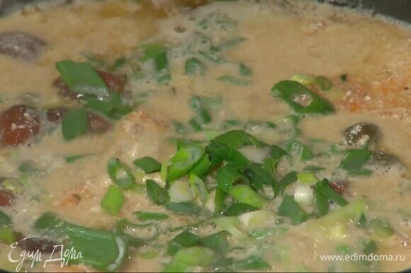 Зеленый лук мелко порезать наискосок и добавить в сковороду с мясом.